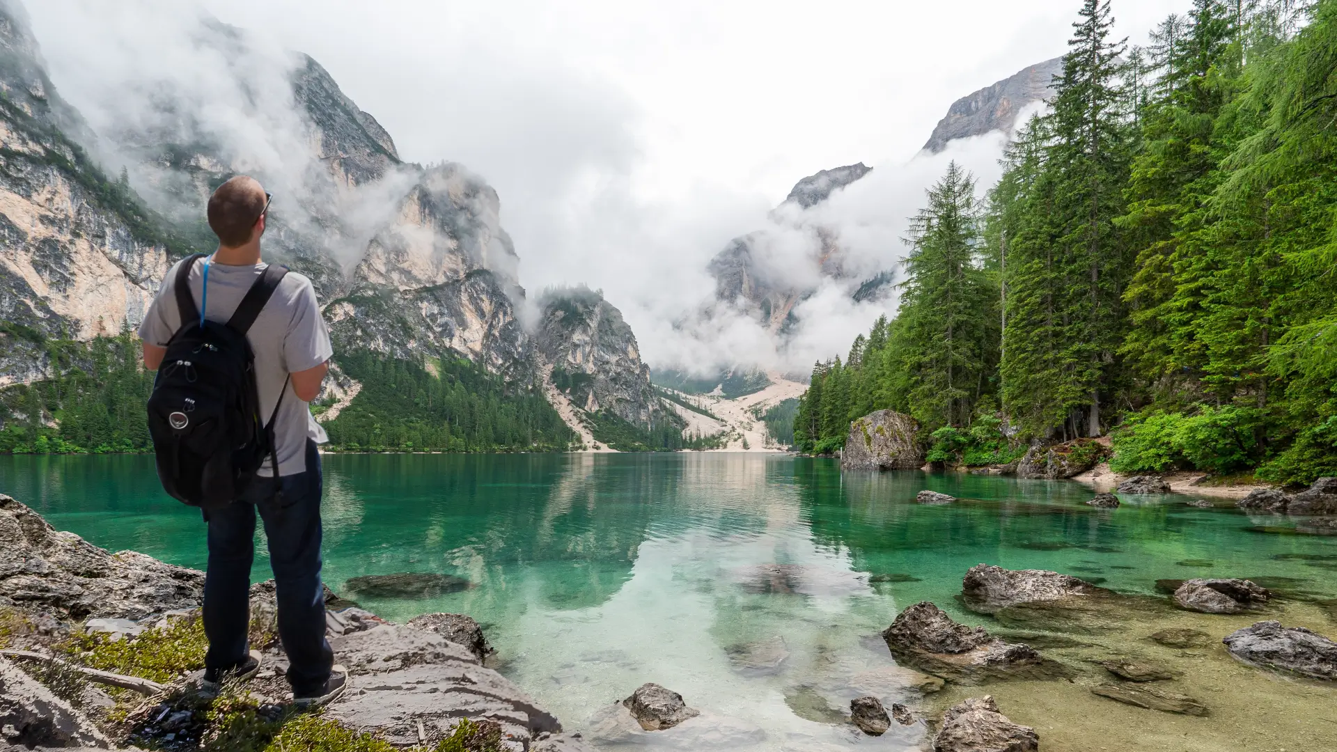 backpacker looking at scenic lake view