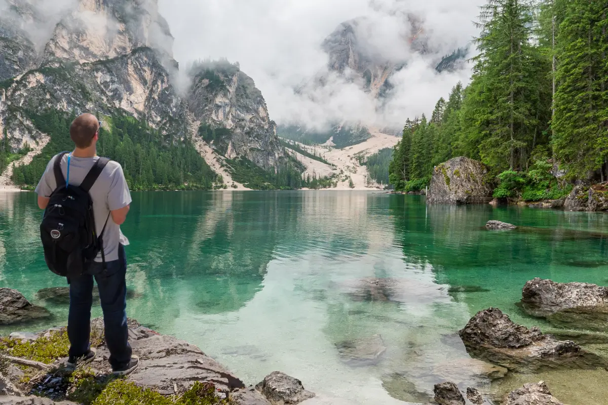 backpacker looking at scenic lake view