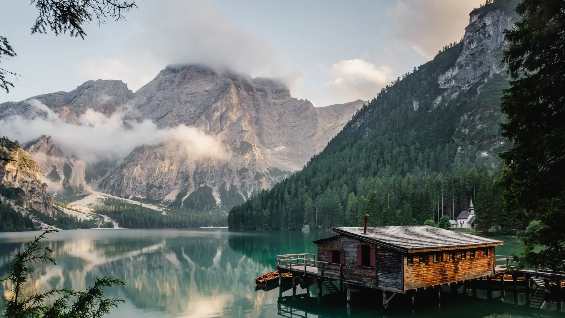 cabin in front of a lake