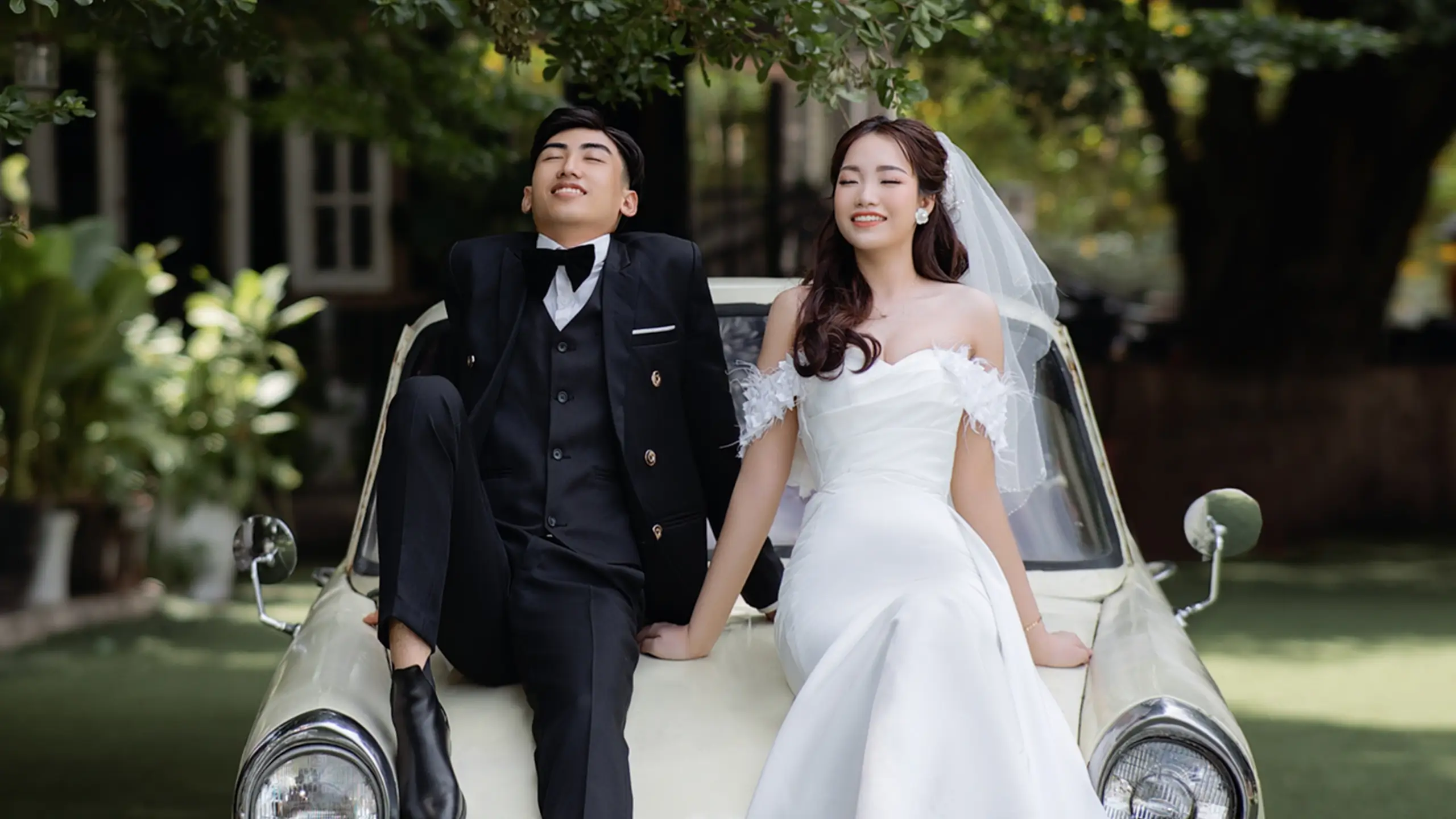 couple sat on car bonnet