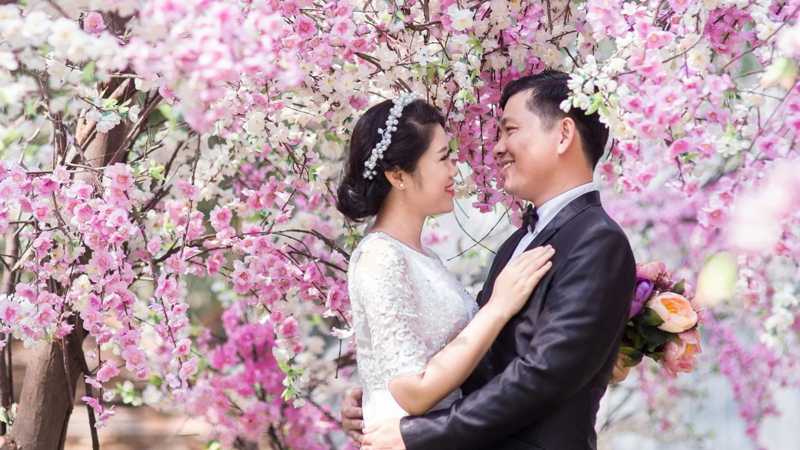 wedding couple under sakura trees